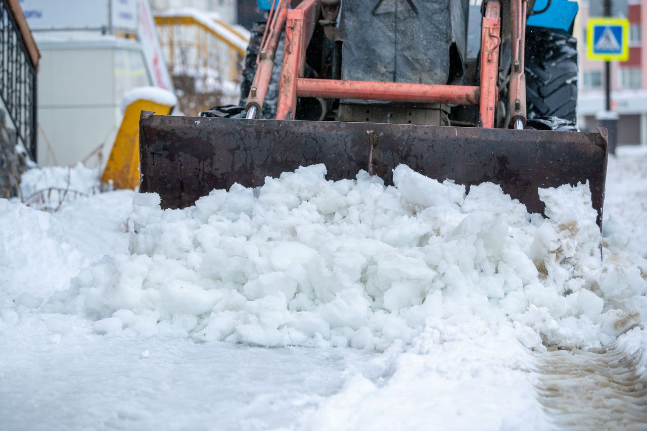 The Art of Drawing Readers In: Your attractive post title goes here Snow plow clearing icy street after heavy winter snowstorm. Extreme cold weather conditions.